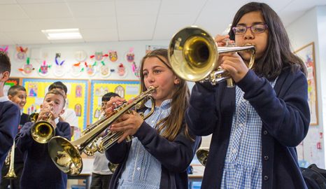 girls playing trumpets